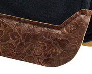 Close up of brown floral wear leather on black saddle pad